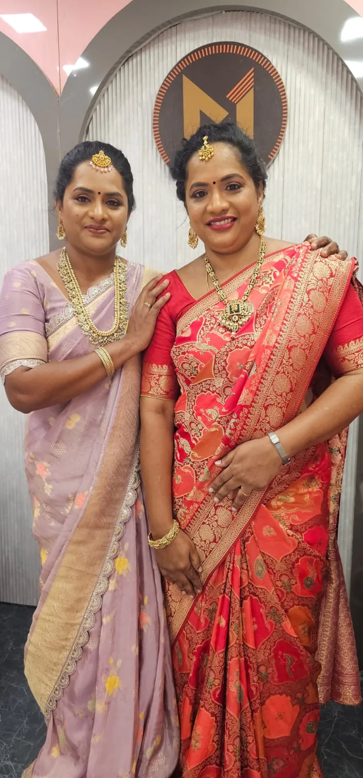 Two bridesmaids in silk sarees and temple jewellery